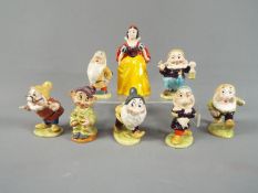 Beswick - A set of Beswick Snow White and the Seven Dwarfs figurines with gold back stamp,