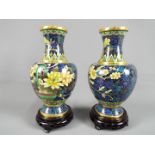 A pair of Chinese cloisonné vases of baluster form decorated with auspicious flowers against a