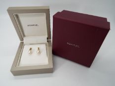 9 ct gold - a pair of 9ct gold stud earrings with pearl design, both with friction backs,