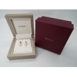 9 ct gold - a pair of 9ct gold stud earrings with pearl design, both with friction backs,