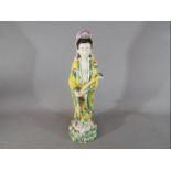 A Chinese 19th century famille rose figurine depicting Guanyin in standing pose,