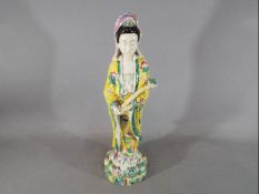 A Chinese 19th century famille rose figurine depicting Guanyin in standing pose,