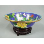 A Chinese cloisonné enamel bowl decorated to the interior and exterior with flowers and butterflies