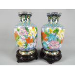 A pair of Chinese cloisonné enamel vases decorated with chrysanthemum and other auspicious flowers,