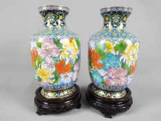 A pair of Chinese cloisonné enamel vases decorated with chrysanthemum and other auspicious flowers,