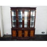 A large Chinese display cabinet with carved walnut panels, brass detailing with two keys,