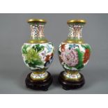 A pair of Chinese cloisonné enamel vases decorated to the body with chrysanthemum and butterfly on