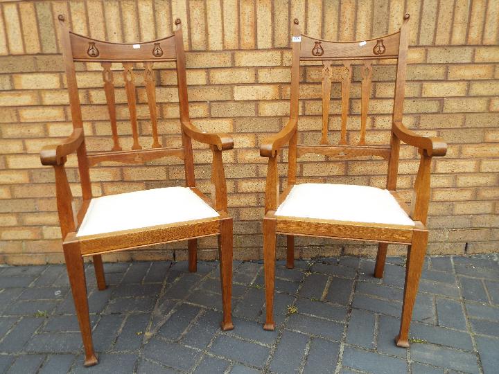 A pair of oak high back chairs with upholstered seats and arm rests - Image 2 of 2