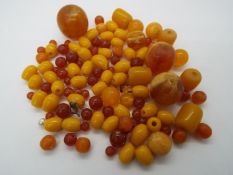 A quantity of various amber beads, largest approximately 26 mm (d), 163 grams all in.