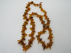 A strand of amber beads, approximately 58 cm (l), in need of re-stringing, 18 grams all in.