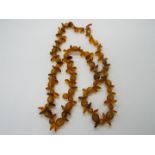 A strand of amber beads, approximately 58 cm (l), in need of re-stringing, 18 grams all in.