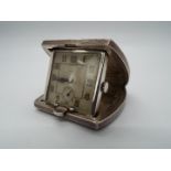 A small silver purse or desk watch/ clock,