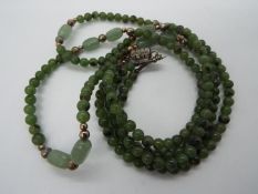 A twin strand jade or hardstone necklace, approximately 47 cm (l),
