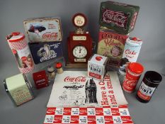 A collection of advertising tins, Coca Cola branded napkin dispensers, toothpick dispensers,