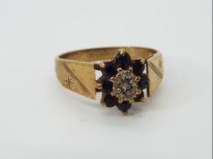 A hallmarked 9ct gold cluster ring, size O 1/2, approximately 3.14 grams all in.