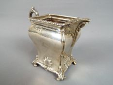 A Victorian silver hallmarked cream jug with chased decoration depicting a recumbent stag below a