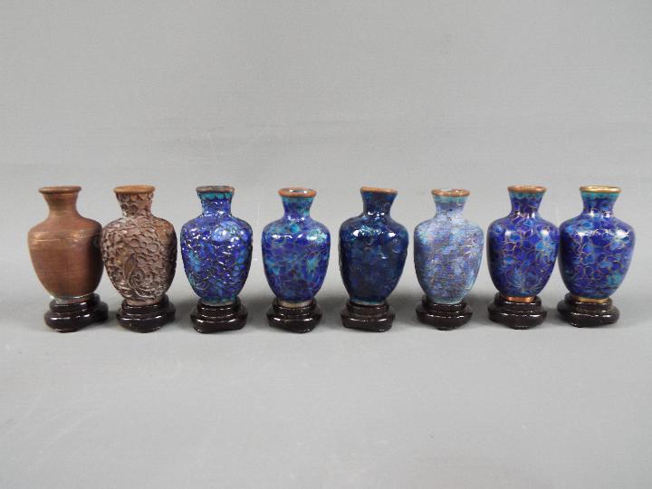 A 20 th century set of eight Chinese vases of baluster form showing the stages of producing a