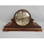 An oak cased Napoleons hat-styled mantel clock, silvered dial with Arabic numerals,