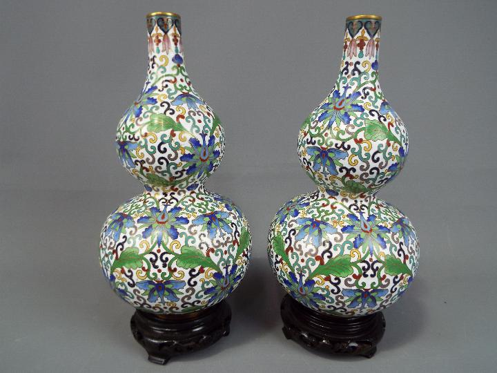 A pair of Chinese double gourd cloisonné vases decorated throughout with stylised lotus scrolls