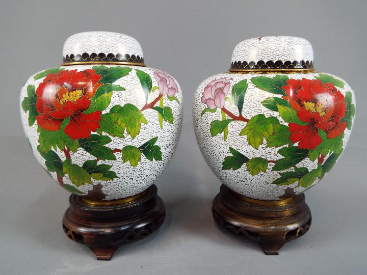 A pair of Chinese cloisonné ginger jars and covers decorated with flowers and butterfly,