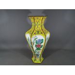 A Chinese early 20th century Canton enamel vase of hexagonal and baluster form with flaring neck,