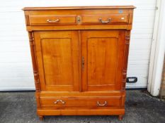 A large sideboard having two drawers over twin doors and a larger lower drawer,