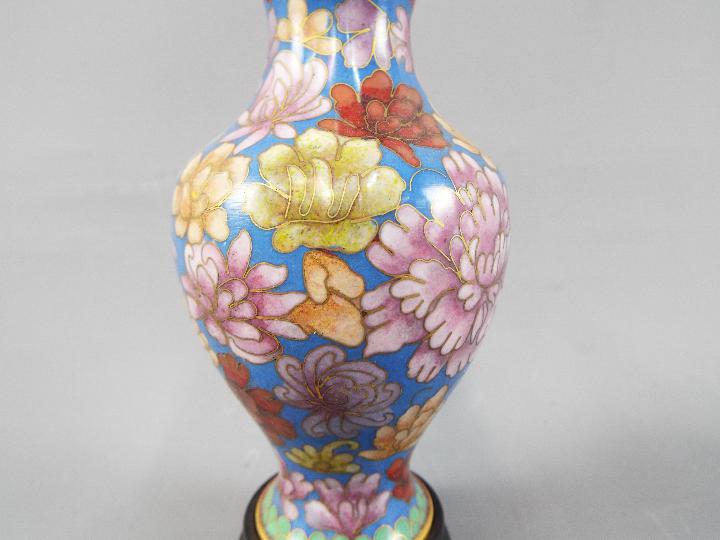 A small pair of Chinese cloisonné vases decorated with chrysanthemum on a blue ground, - Image 2 of 4