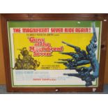 A framed movie poster 'Guns of the Magnificent Seven', approximately 74.5 cm x 101 cm image size.