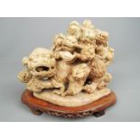A large highly detailed Chinese soapstone carving depicting an adult Guardian Lion with eight