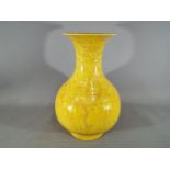 A large Chinese yellow glazed baluster vase with everted rim,