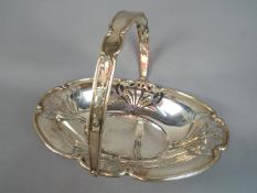 An Edward VII silver hallmarked fruit bowl with swing handle by Mappin Brothers,