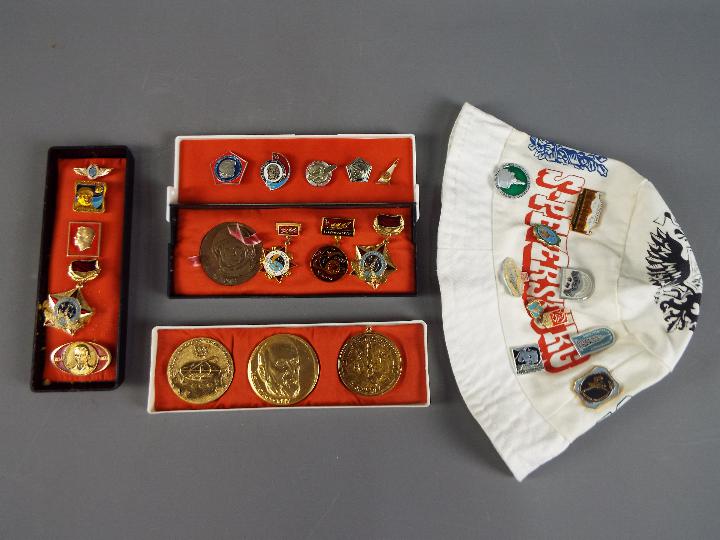 A collection of commemorative Soviet Russian badges and similar.