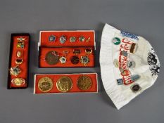 A collection of commemorative Soviet Russian badges and similar.