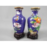 A small pair of Chinese cloisonné vases decorated with flowers and butterfly against a blue ground,