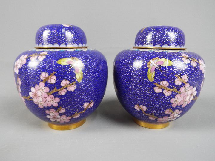 A pair of Chinese cloisonné covered ginger jars decorated with blossom and insects on a blue ground, - Image 2 of 2