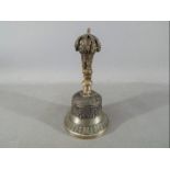 A Chinese Tibetan bronze ceremonial bell, with a gilt vajra shaped handle,