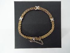 925 Silver - a double stranded rope bracelet with a three X stone set design,