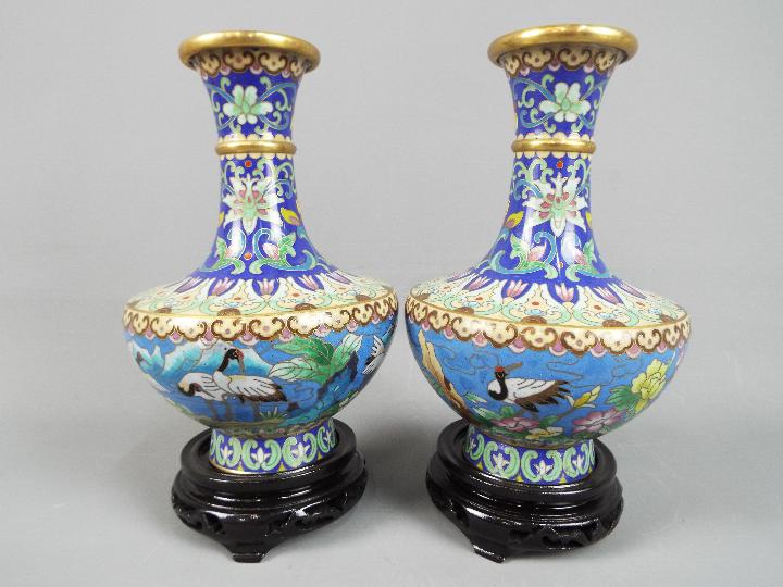 A pair of Chinese cloisonné vases decorated to the body with Red Crowned Cranes in a landscape