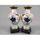A small pair of Chinese cloisonné vases with floral decoration on a white ground,