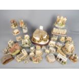 A collection of Lilliput Lane and similar model cottages and buildings including Britain's