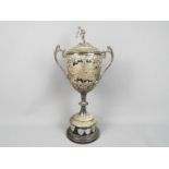 Silver - A large Silver Edward VII twin handled trophy with repousse decoration,