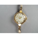 A lady's 9ct gold Garrard wristwatch with octagonal case and link bracelet, stamped .