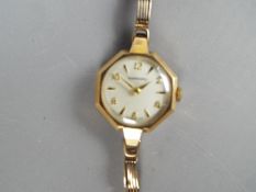 A lady's 9ct gold Garrard wristwatch with octagonal case and link bracelet, stamped .