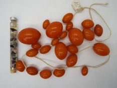 A graduated amber bead necklace, in need of re-stringing, largest bead 30 mm x 22 mm,