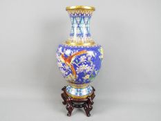 A large Chinese cloisonné vase decorated to the body with flowers,