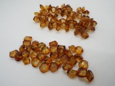 An amber bead necklace, in need of re-stringing, approximately 12 mm x 10 mm typical bead size,
