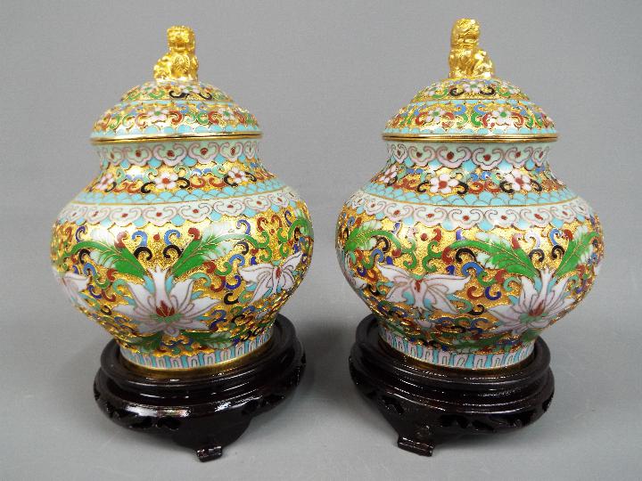 A pair of Chinese cloisonné covered vases with stylised floral decoration,