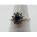 A 9ct white gold cluster ring size Q, central stone measuring approximately 6 mm x 4 mm,