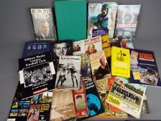 A collection of sporting interest books and magazines covering cricket, Olympics, boxing and other.