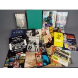 A collection of sporting interest books and magazines covering cricket, Olympics, boxing and other.